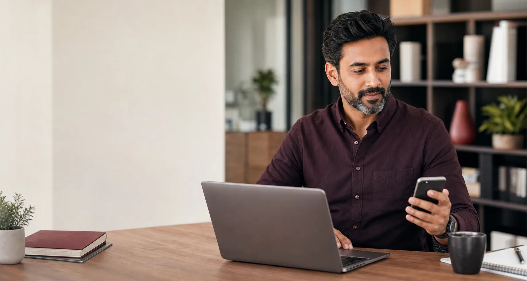 Small business owner managing professional Titan email on a laptop and phone