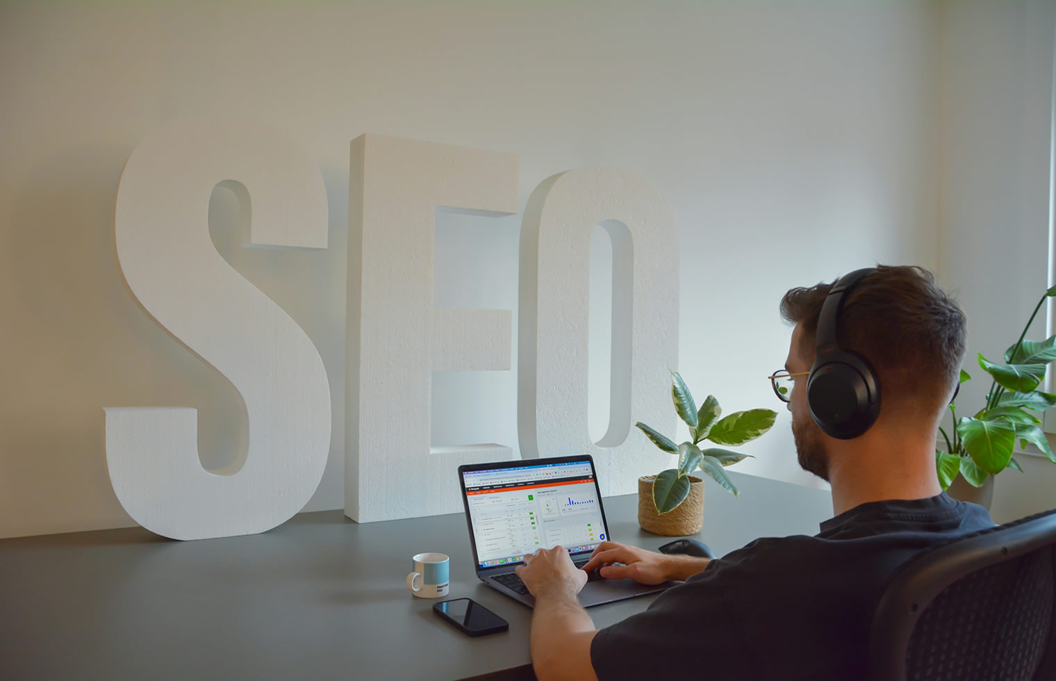 SEO specialist reviewing website search performance at a laptop